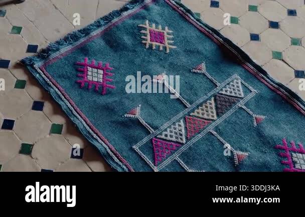 A vibrant blue Moroccan rug with colorful, traditional Berber patterns ...