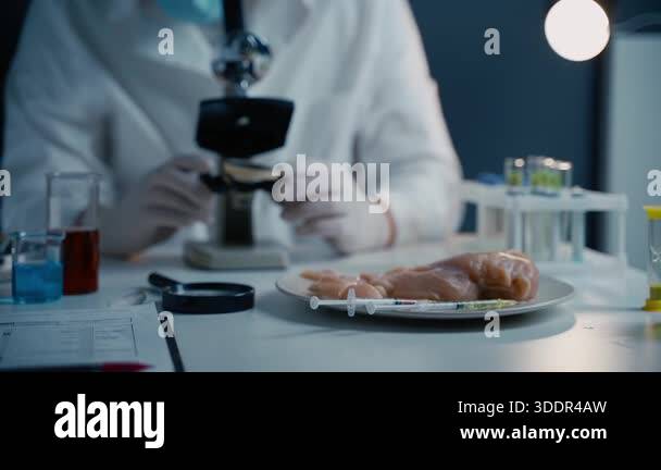 Young male nutrition expert testing food products in lab. Genetic ...