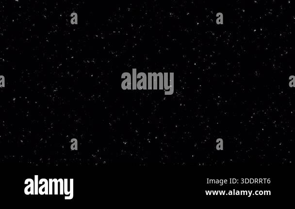 Abstract white particles floating and shimmering on a black background ...
