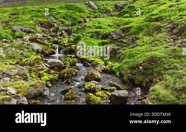 Water rushing over rocks in mountain stream. Rushing water cascades ...