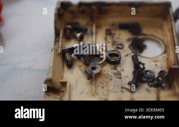 Various machine components and mechanical tools arranged on a table ...
