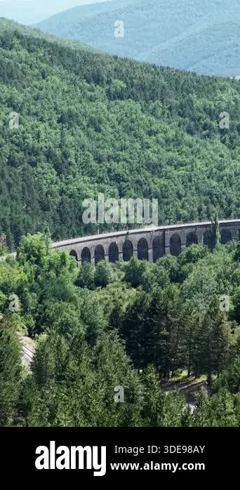 Beautiful panoramic view of an ancient roman style aqueduct nestled in ...