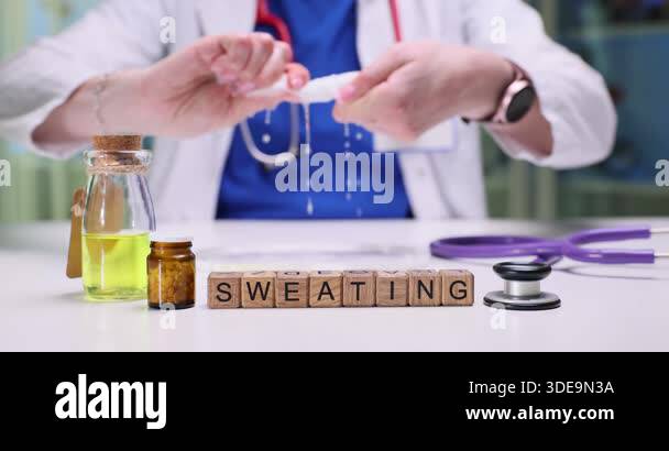 Woman physician twists wet cloth with hands and water drips slowly ...