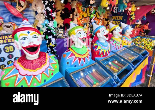 Clown heads at a colorful carnival game Stock Video Footage - Alamy