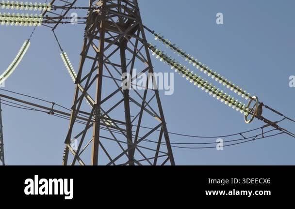 Detailed image of a high voltage transmission tower featuring glass ...