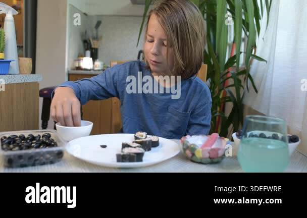 Child Eating Routine Child eating and drinking at home table. Calm everyday moment of a kid ...