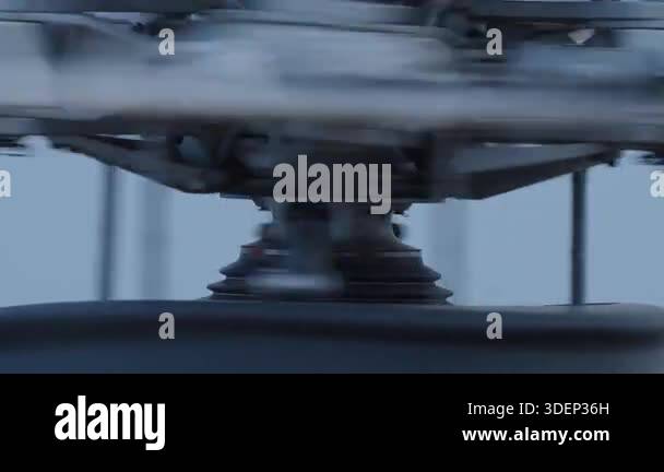 Close view of helicopter rotor hub with spinning blades and mechanical ...