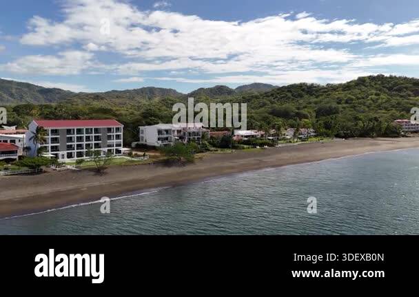 Aerial Rising Beachfront Residence Overlooking Lush Jungle Mountains Of aerial-rising-beachfront-residence-overlooking-lush-jungle-mountains-of