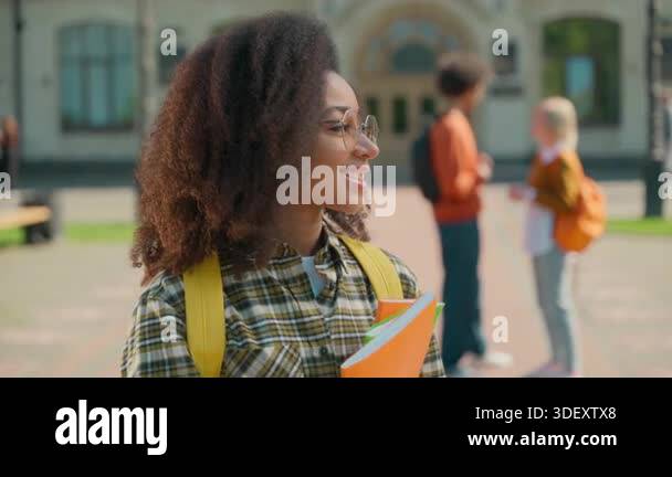 Portrait African American female student smiling in glasses looking at ...