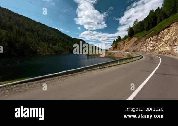 First-person view from the windshield of a car. Driving on an asphalt ...