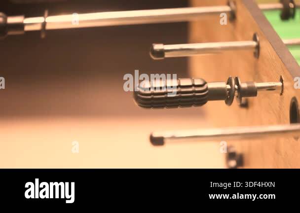 Foosball table rods close-up showing handles of popular tabletop soccer ...