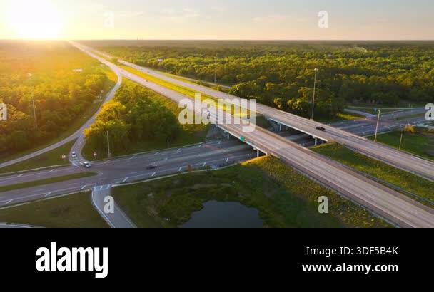 Wide multilane expressway crossroad with overpass ramps and flowing ...