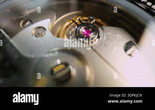 Ruby Watch Mechanism Extreme close-up of a mechanical watch movement showing the balance ...