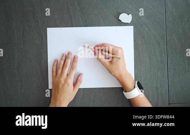 Close up of woman hands drawing pencil doodles on paper during break in ...