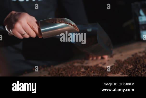 Roasted coffee beans fly and spin on a black background in slow motion ...