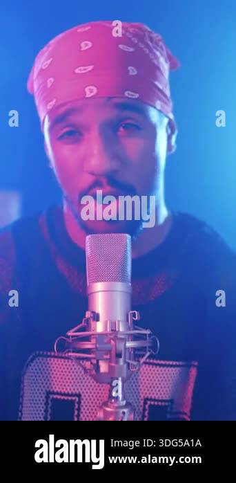 Young Mace Rapper Passionate young male rapper performing his song, singing into a ...
