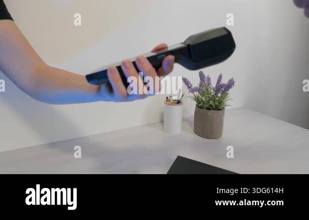 Slow motion card payment on POS terminal during retail checkout process ...