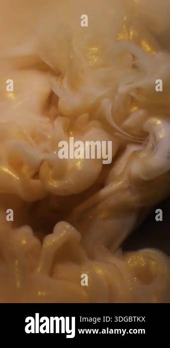 Vertical video. Swirling fluid. Paint background. Defocused yellow ...