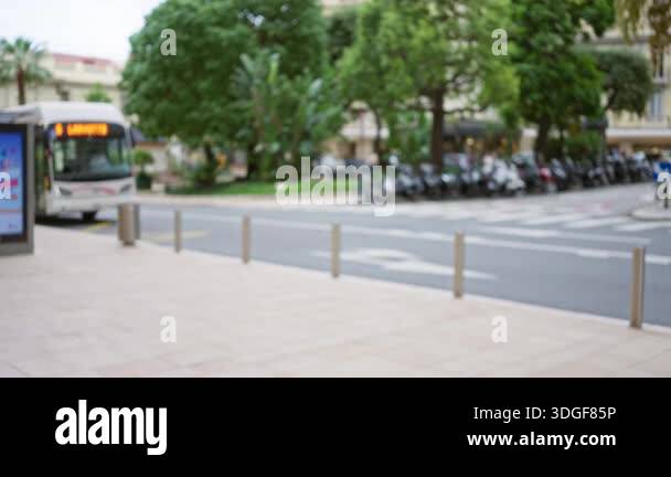 Blurred street scene in monaco showing a defocused bus and lush ...
