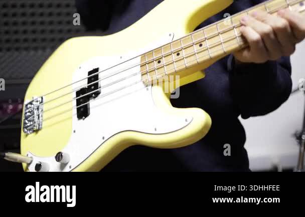 Musician playing bass guitar strings close-up, music performance and ...