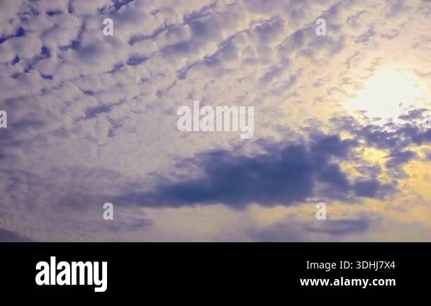 Stunning time lapse footage of white altocumulus clouds moving across a ...