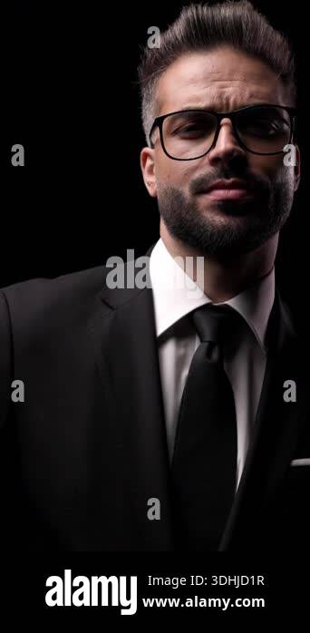 Closeup portrait of a serious mysterious man in a suit and glasses ...