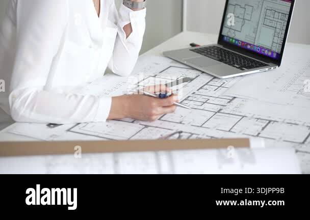 Architect hands measuring and drawing on detailed blueprints, creating ...