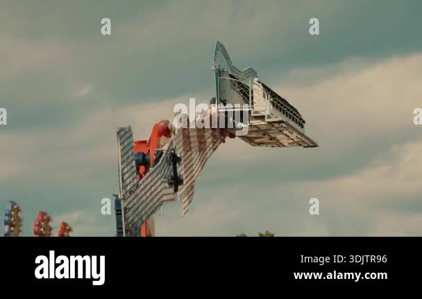 Spinning pendulum carousel in motion at a local funfair. High-speed ...