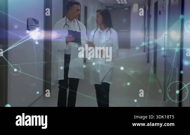 Woman pointing tablet and doctor tapping while walking hospital hallway ...