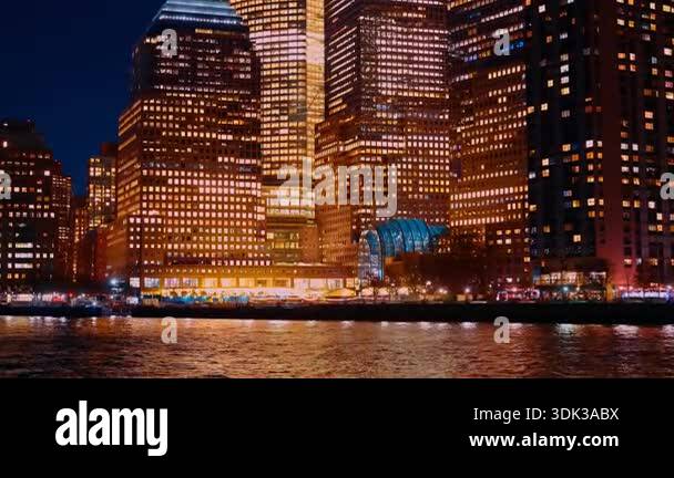 City skyline at night with lights reflecting on the water surface. Tall ...