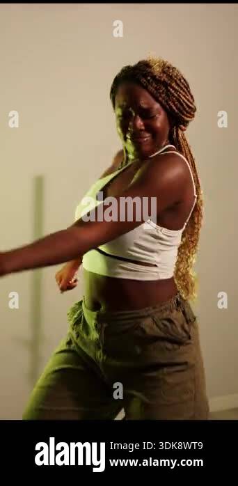 Happy african american woman with long braids enjoying afrodance ...