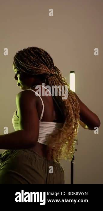 Beautiful african woman with long braids dancing modern afrobeats. An ...