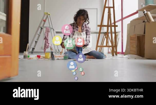 Image showcasing Artist dipping brush into paint spawning social media icons floating in ...