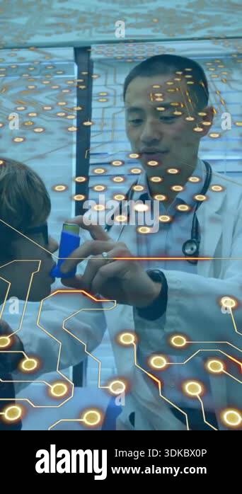 Microprocessor connections against asian male doctor teaching to use ...