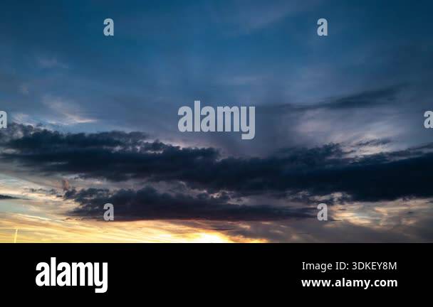 Time lapse of dramatic clouds moving across the sky at sunset. Fast ...