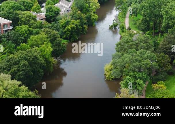 Drone footage shows swollen river overflowing its banks near homes and ...
