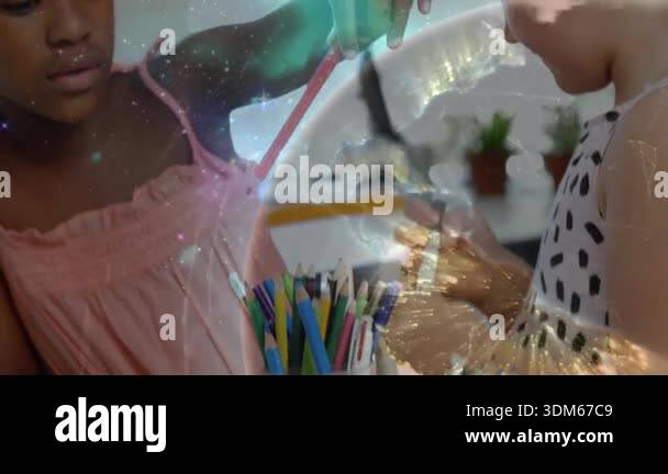 Girls sorting colored pencils at craft table causing swirling galaxy ...