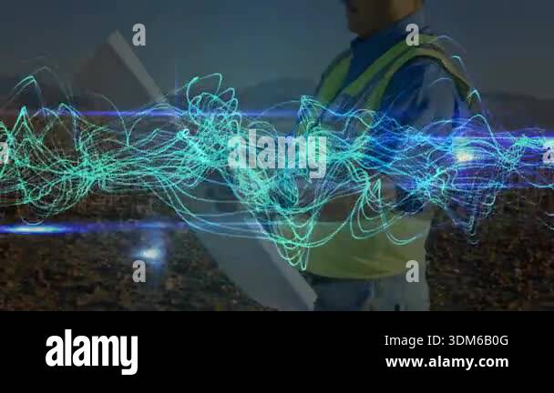 engineer entering field holding tablet starting turquoise waves while ...
