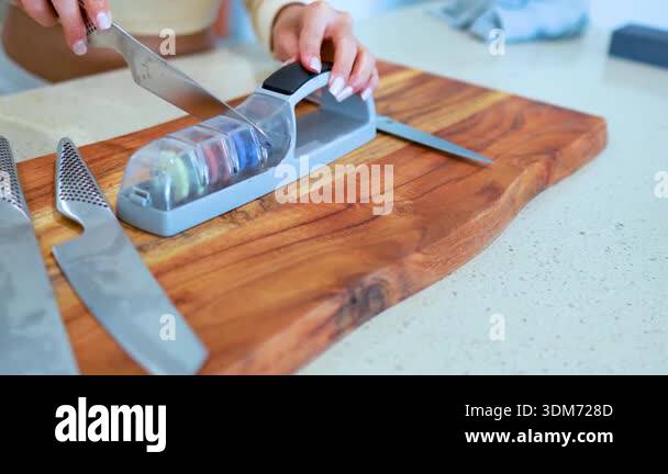 A persons hand chooses and removes a metal bar attachment from a gym ...