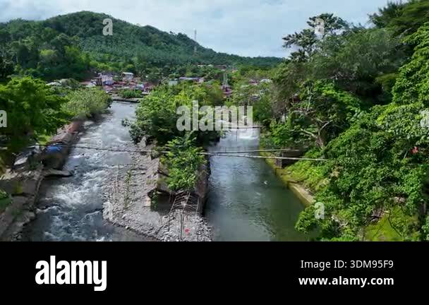 Above the jungle fringed Bohorok River, Bukit Lawang on Sumatra nestles ...