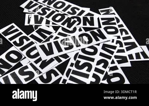 Vision text written on the pieces of paper with black backdrop ...
