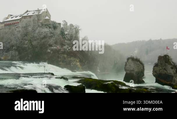 Water rushes over rocks at Rhein Falls near Schaffhausen. A historic ...
