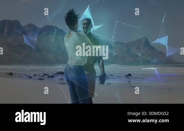 Couple spinning on beach, creating blue network lines and 3D globe ...