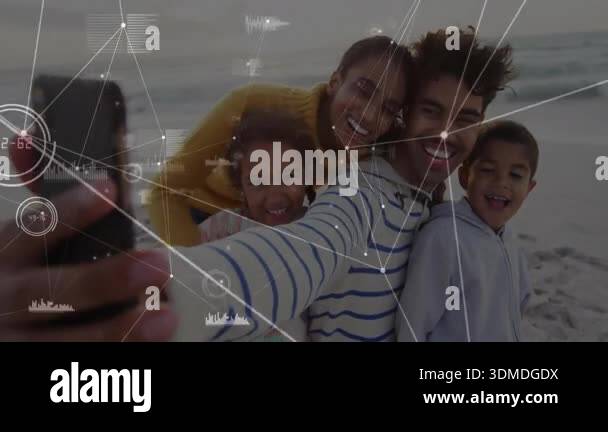 Man holding phone and aligning family on beach, tapping shutter ...