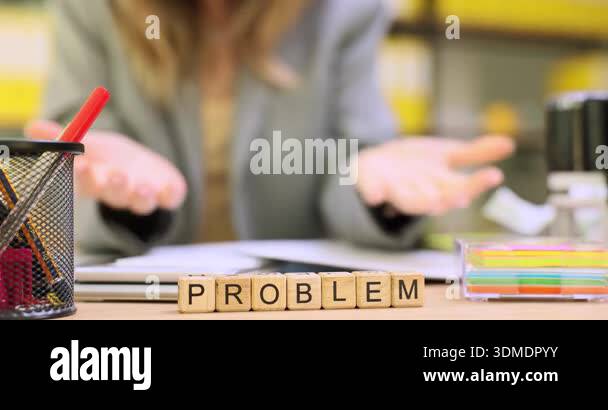 Woman office worker sits at desk and taps irritably on documents facing ...