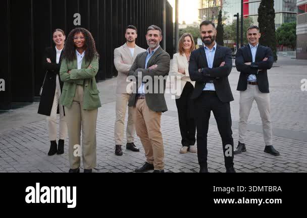 Confident business people team standing together outside modern office ...