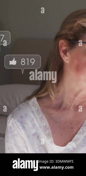 Sitting in bedroom, woman receiving social media notifications ...