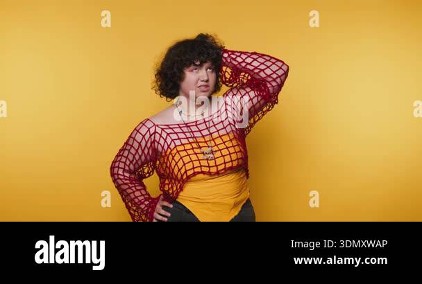A model shows different poses in a photo session at a studio with a ...