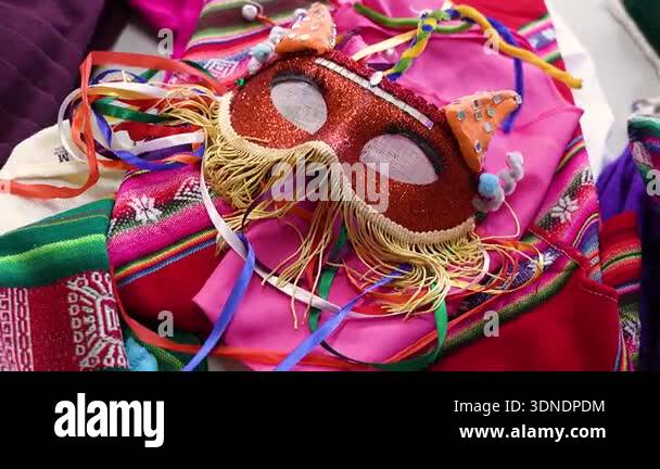 Andean Ribbons A vibrant red glittery carnival mask with golden fringe and ribbons ...