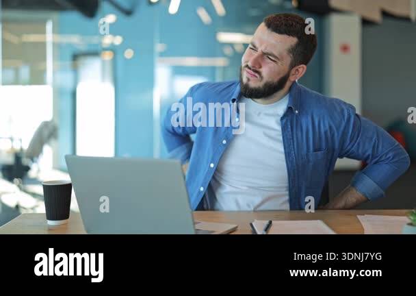 Office worker experiences acute back pain and discomfort while sitting ...